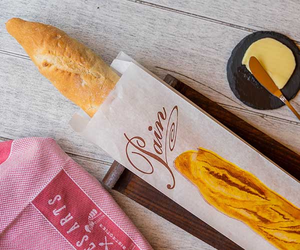 Fresh baguette presented in Bistro des Arts branding