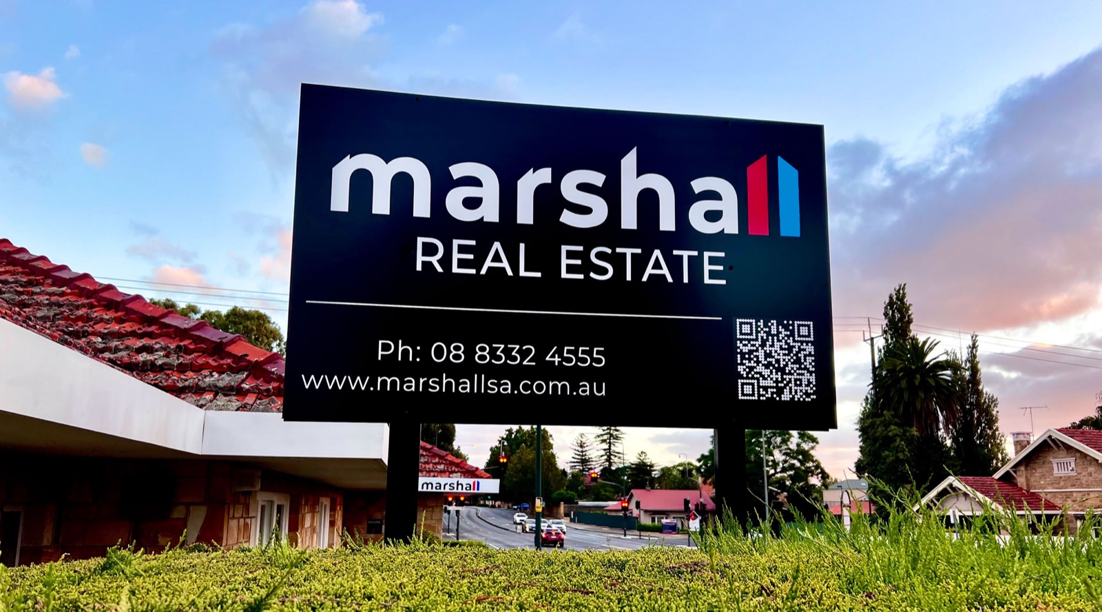 Marshall SA Real Estate sign beneath an Adelaide sky