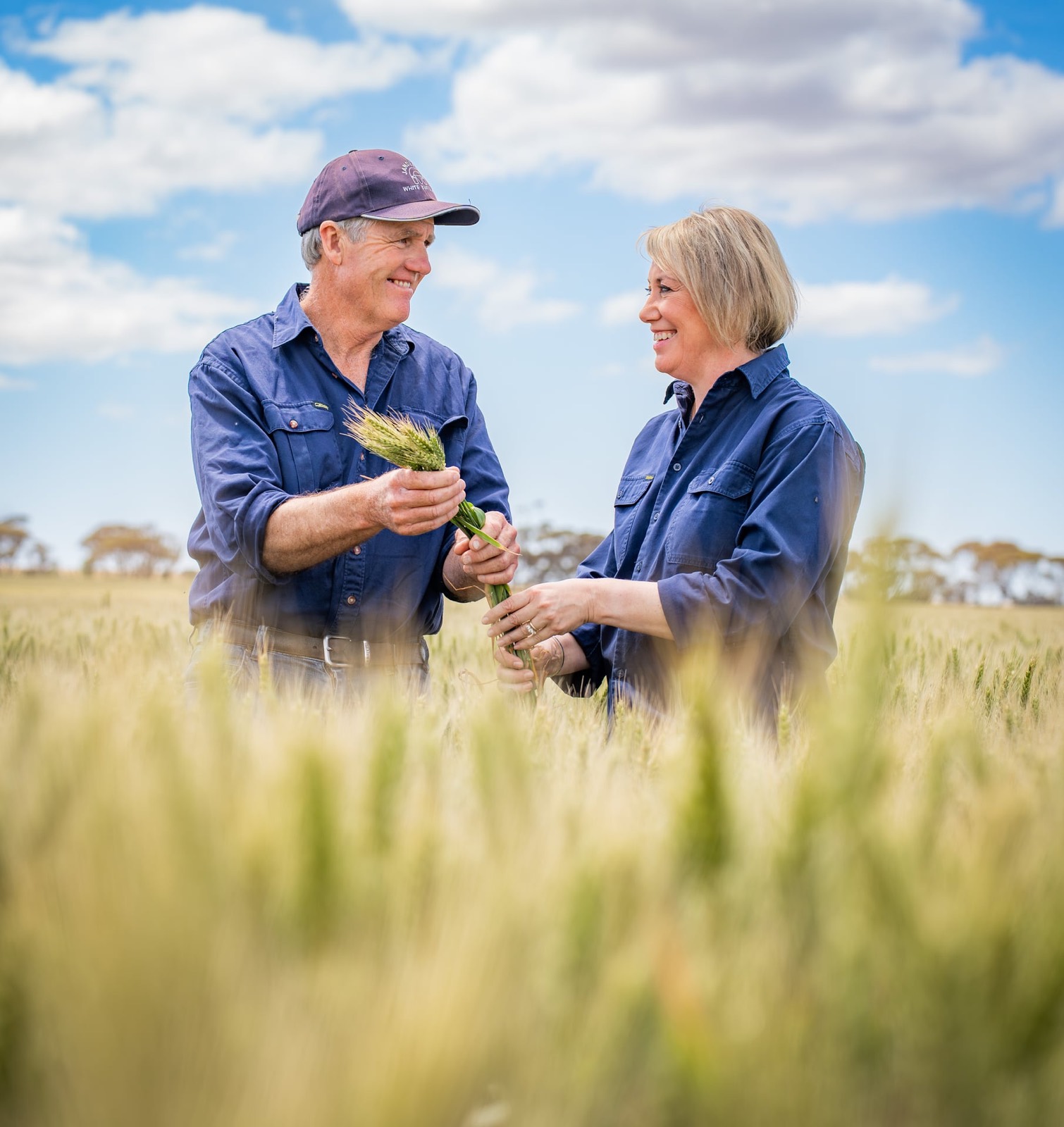 Two grain growers standing together in a field